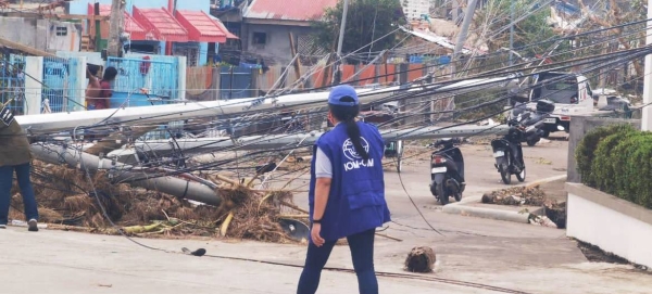 An IOM team on the ground in Camarines Sur, one of the regions badly hit by Typhoon Goni, locally known as Rolly. With transport links damaged, the team uses a boat to reach the affected areas.— Courtesy photo