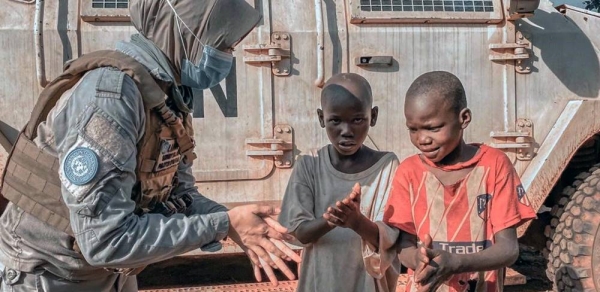 

A peacekeeper with MINUSCA, the UN mission in the Central African Republic, explains to two young boys how to properly apply hand sanitizer as protection against coronavirus. — courtesy MINUSCA/Indonesia FPU