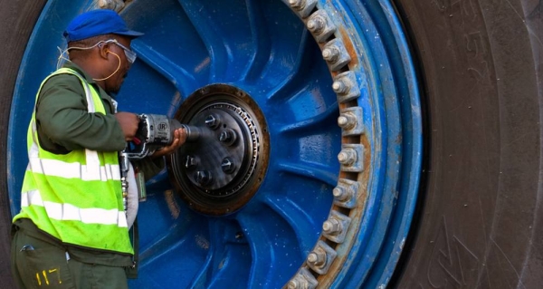 A worker repairs a wheel of a giant haul truck at a uranium mine in Namibia. —courtesy World Bank/John Hogg