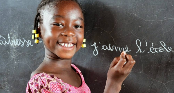 A girl writes on a blackboard at a school in Fada, eastern Burkina Faso, after returning to her class. Schools in the country had been closed for months due to COVID-19 mitigation measures. — courtesy UNICEF/Dejongh