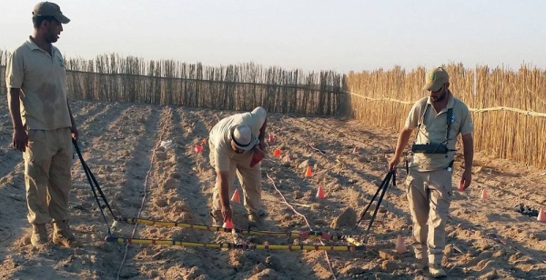 A team of mien clearance experts searches for cluster bombs in a plowed field in Iraq. — courtesy DMA/RMAC-S Iraq