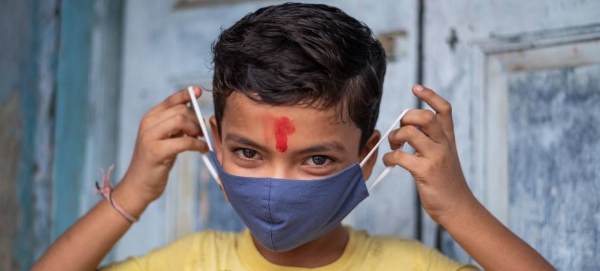 An 11-year-old boy in India demonstrates the correct way to wear a mask. — Courtesy photo