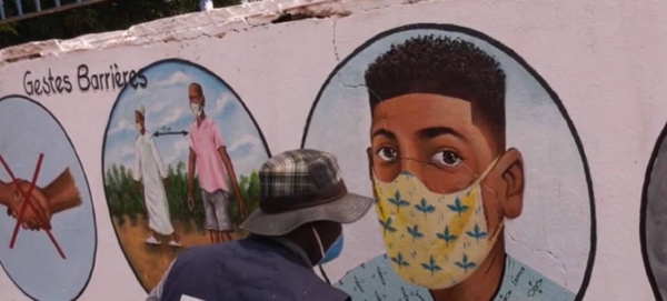 Artist in the Central African Republic, CAR, painting on walls various tips on how to protect oneself from COVID-19. — Courtesy photo