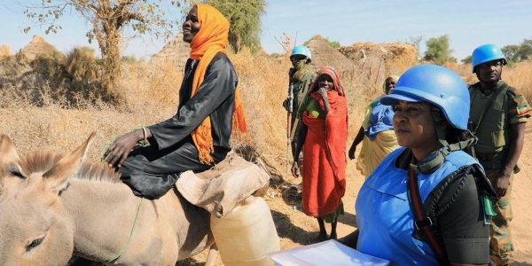 Peacekeepers from the African Union-UN Hybrid Operation in Darfur (UNAMID) provide protection to local women in Aurokuom village, Sudan. — courtesy UNAMID/Amin Ismail