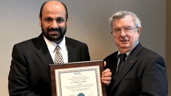 Ahmed S. Khogeer is presented with a Fellowship Award by David Eckhardt, vice chairman of the American Institute of Chemical Engineers Fellows Council. — File photo 