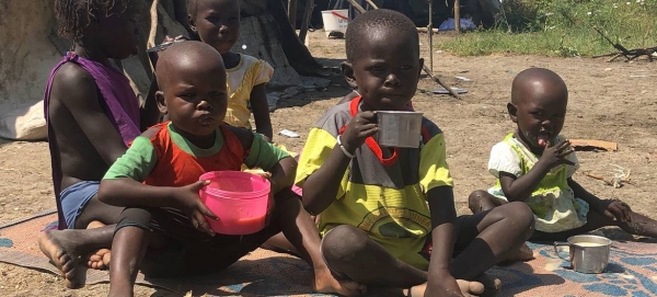 Children eat porridge their mother cooked with the food she received at a World Food Programme (WFP) distribution site in Pibor, South Sudan. — Courtesy file photo