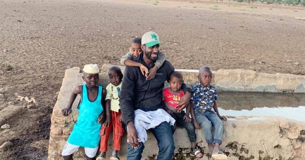 UN News' Abdelmonem Makki and his nephews in the village where he was raised in South Darfur, Sudan. — courtesy UN News/Abdelmonem Makki