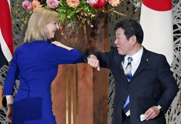 File photo on Oct. 23, 2020, shows Japanese Foreign Minister Toshimitsu Motegi (R) and British International Trade Secretary Liz Truss bump elbows in Tokyo, after signing a post-Brexit bilateral free trade agreement. — courtesy Kyodo