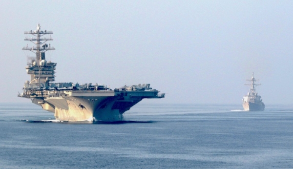 USS Nimitz (CVN-68), the guided-missile destroyer USS John Paul Jones (DDG-53) sail in formation during a scheduled transit of the Strait of Hormuz in this Nov. 9, 2020 courtesy file photo. 