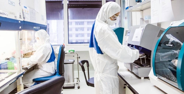 Laboratory technicians work at a viral zoonoses research center in Bangkok, Thailand. — courtesy WHO/P. Phutpheng