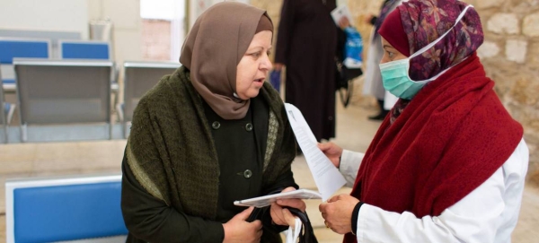 A health worker provides COVID-19 information to a patient visiting the Jerusalem Health Center. — Courtesy photo