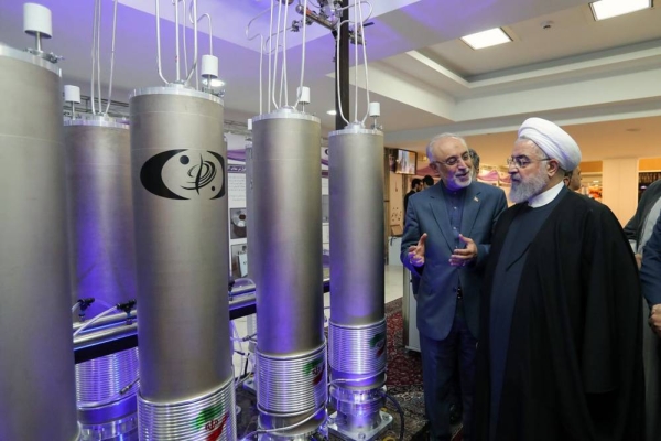 File photo of Iranian President Hassan Rouhani seen at an exhibition of Iranian nuclear technologies, standing next to model centrifuges used to refine uranium and other nuclear materials.
