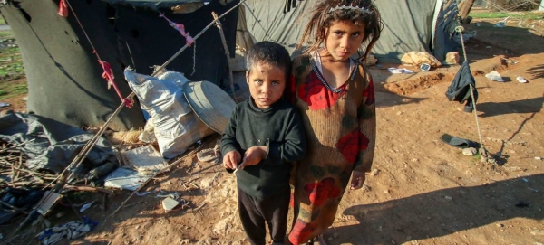 Children stand outside the tent where they live in a remote desert camp in southern rural Homs, Syria. — Courtesy photo