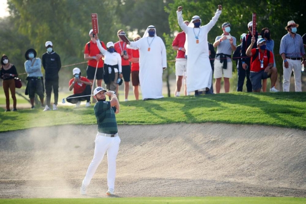 Tyrrell Hatton of England poses for a photograph with the trophy following victory during Day 4 of the Abu Dhabi HSBC Championship at Abu Dhabi Golf Club on Sunday in Abu Dhabi, United Arab Emirates. (Photo by Warren Little)