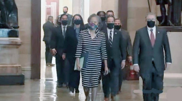 A TV grab shows the impeachment managers wearing black masks and walking two-by-two through the very halls where rioters had overtaken the Capitol earlier this month in a deadly siege, being led into the Senate chamber by the lead impeachment manager, Rep. Jamie Raskin of Maryland, who read the article of impeachment.
