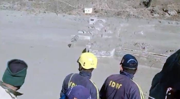 TV grab shows rescue workers look at the flood-ravaged area following  a massive avalanche and resultant flooding in the north Indian state of Uttarakhand’s Chamoli Saturday.