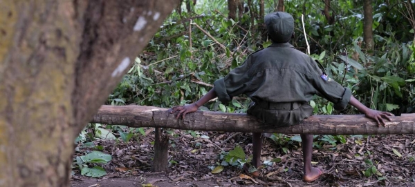 A child solider sits on a log during a ceremony to release children from an armed group in South Sudan, in 2018. However, the risks of recruitment and use of children by armed forces and groups have risen due to the impact of the COVID-19 pandemic. — Courtesy photo
