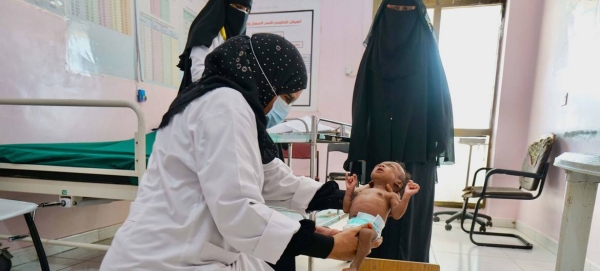 A two-month-old baby suffering from severe malnutrition is weighed and measured by a nurse in a hospital in Aden, Yemen. — Courtesy file photo