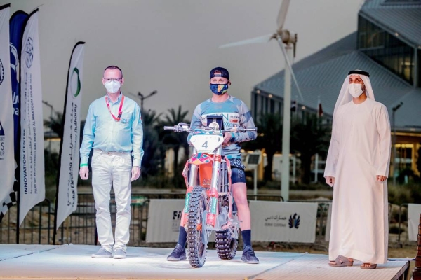 Saudi Arabia’s Yazeed Al Rajhi and co-driver Michael Orr, with Emirates Motorsports Organization CEO Mahir Badri.