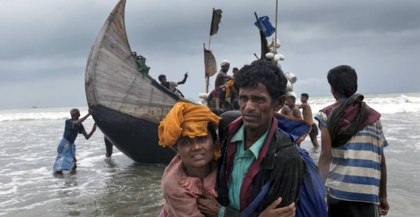 File photo shows a man helps a woman to the shore, as a boat arrives with Rohingya refugees in Teknaf, Cox’s Bazar, Bangladesh. — courtesy UNICEF/Patrick Brown