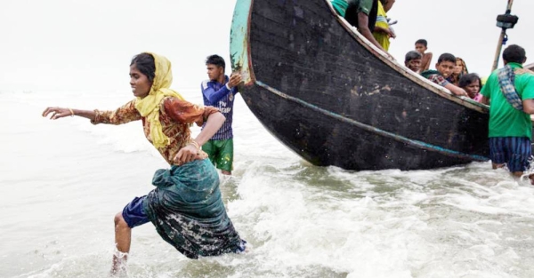 File photo shows a man helps a woman to the shore, as a boat arrives with Rohingya refugees in Teknaf, Cox’s Bazar, Bangladesh. — courtesy UNICEF/Patrick Brown