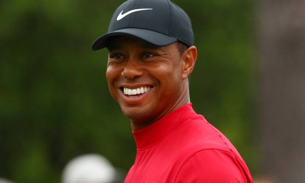 Apr 14, 2019; Augusta, GA, USA; Tiger Woods smiles as he walks off the 8th tee during the final round of The Masters golf tournament at Augusta National Golf Club. Mandatory Credit: Rob Schumacher-USA TODAY Sports