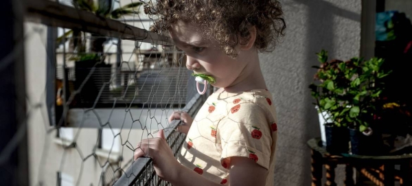 A three-year-old child looks outside their home in Lyon, France, during a lockdown due to the coronavirus pandemic. — Courtesy photo
