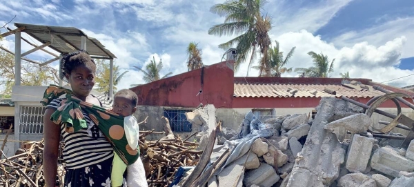 A woman and her baby stand in the rubble of Cyclone Idai that struck central Mozambique in 2019. — Courtesy photo