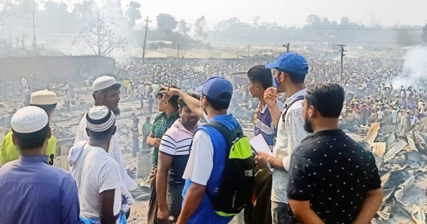 IOM personnel at Kutupalong refugee camp in Bangladesh. In the background are the tens of thousands of refugees displaced after the fire. — courtesy IOM Photo