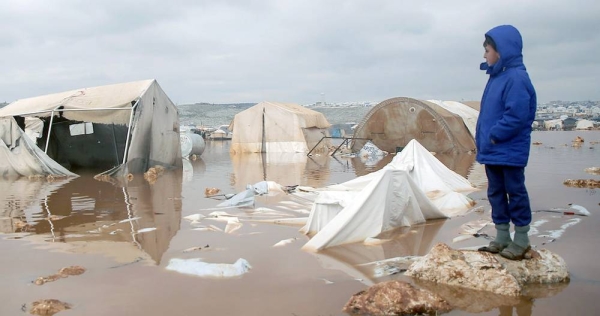 A child looks over a flooded area of Kafr Losin Camp in north-west Syria. — courtesy UNICEF/Khaled Akacha