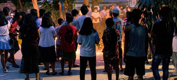 People are seen holding a vigil in Yangon, Myanmar, in this file photo.