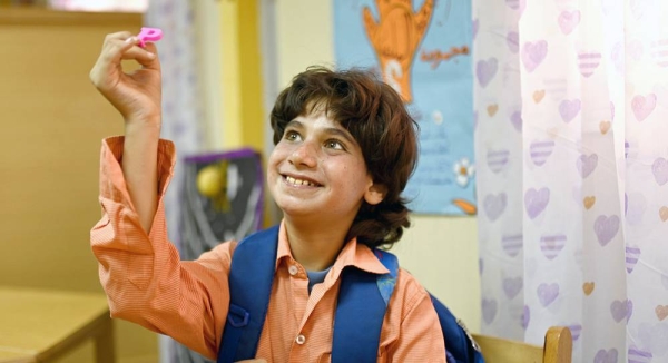 Mahmoud, who has autism, holding the letter P he was asked to find at his classroom in Egypt. — courtesy UNICEF/Rehab El-Dalil