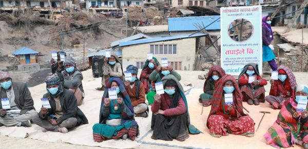 


Elderly people at a remote village in Nepal hold up their vaccination cards after receiving COVID-19 vaccines. A sign behind them encourages everyone to receive the vaccines and highlights ways to protect oneself from the disease. — courtesy UNICEF/Laxmi Prasad Ngakhusi