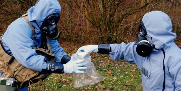 OPCW inspectors, in full protective gear, collecting samples during a mock exercise. — courtesy OPCW