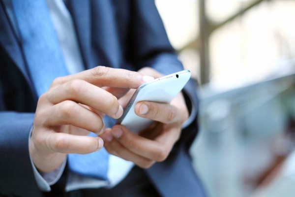 Close up of a man using mobile smart phone