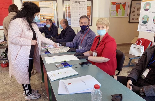 A voter goes to a poll center as Albanians cast their vote Sunday amid the COVID-19 pandemic.