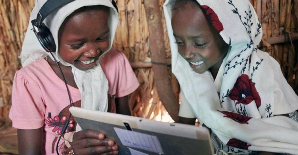 
Children use their tablet at a UNICEF supported learning center in a village on the outskirts of Kassala, in Eastern Sudan. — courtesy UNICEF/Shehzad Noorani