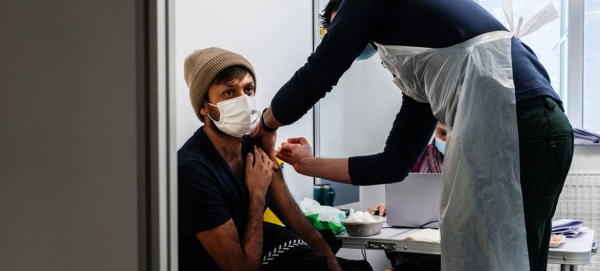 A 33-year-old man gets a COVID-19 vaccine in London in this file photo.