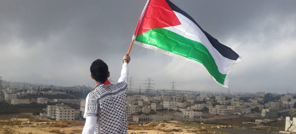 A young man waves a flag of Palestine in this file picture. 
