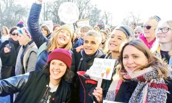 London Mayor Sadiq Khan, a member of Britain's Labour Party, takes a selfie with a group of supporters during his campaign. He secured a second term in office as London Mayor on Saturday.