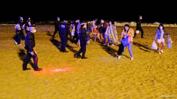 Law enforcement officers in Barcelona were called in to disperse people drinking and dancing in the city center and on a nearby beach in the first weekend since Spain lifted its state of emergency. — Courtesy photo