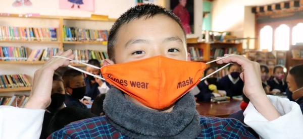 A grade six student in Paro, Bhutan, promotes the wearing of facemasks. — courtesy UNICEF/Sonam Pelden