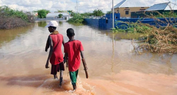 Young boys walk through a section of a flooded residential area in Belet Weyne, Somalia. — courtesy UN Photo/Ilyas Ahmed