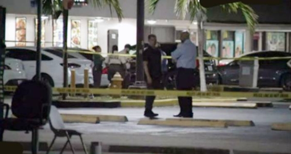 A videograb of the the Miami Dade police cordoning off the crime area . The police are looking for the assailants who opened fire at a Florida club Sunday, killing at least two people and wounding at least 20 more.