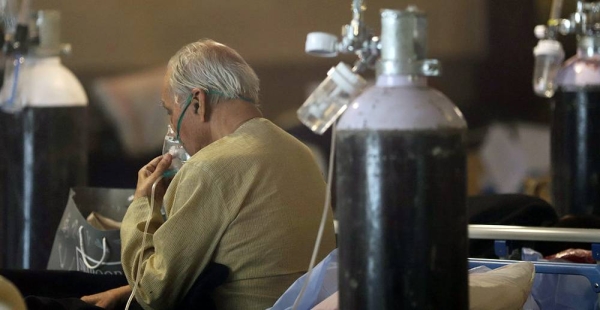A patient receives oxygen treatment in a banquet hall, temporarily converted into a COVID-19 emergency ward in New Delhi, India. — courtesy UNICEF/Amerjeet Singh