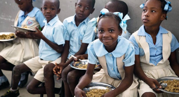Children at a school in Haiti enjoy food provided as part of WFP's school canteen program. — courtesy UN Photo/Leonora Baumann