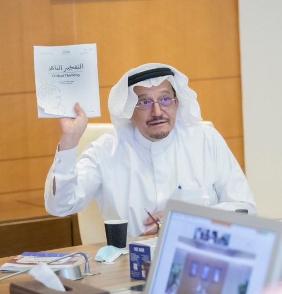 Minister of Education Hamad Bin Muhammad Al-Sheikh is seen holding a copy of the critical thinking curriculum that will be introduced in public schools for the first time in the next semester. — (Ministry of Education)