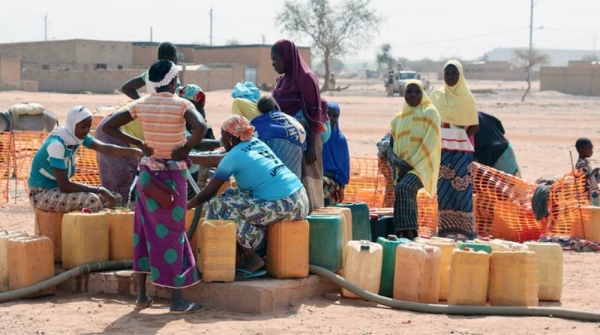 A group of displaced women collect water in the town of Djibo in Burkina Faso. — courtesy UNOCHA/Naomi Frerotte