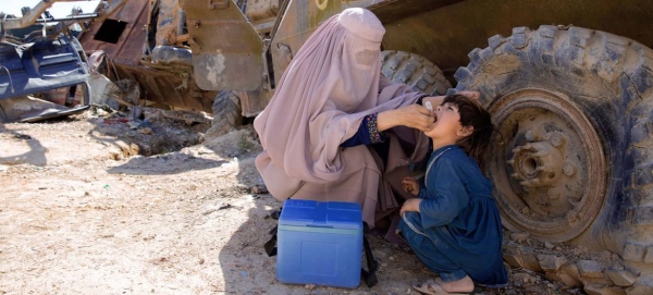 A UN-supported polio worker in Afghanistan administers a polio vaccine to a young child. — Courtesy file photo
