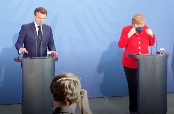 A videograb of German Chancellor Angela Merkel and French President Emmanuel Macron addressing a press conference in Berlin.